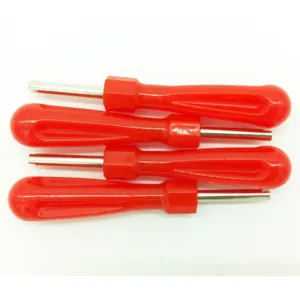 Valve core wrench tool detail shot, red plastic handle metal shaft, practical tire deflation tool
