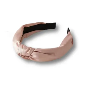 Detailed close-up view of pink satin knotted headband, retro wide design for daily wear.