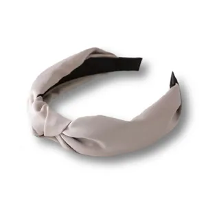 Detailed view of the wide satin knotted headband showcasing fine texture and elegant French style.