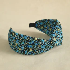 Close-up detail of a floral print knotted headband, elegant wide hair hoop for daily wear.