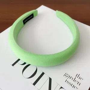 Light green padded headband detail close-up, soft cloth wrapped sponge hair hoop for daily wear.
