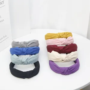 Detailed view of colorful knotted headbands in solid fabric style for daily hair styling.