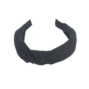 Detailed view of black knotted wide headband, simple design for daily wear and face washing.