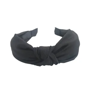 Serre-tete en tissu noue noir, cerceau de cheveux large et uni pour un style elegant.