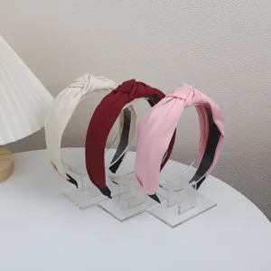 Detailed view of chic knotted fabric headbands in neutral and pastel tones for women.