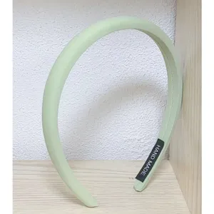 Light green sponge headband detail view, stylish candy color hair accessory for women.