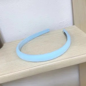 Detailed view of a light blue padded headband, simple and versatile hair accessory.