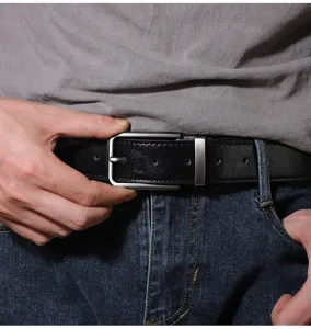 Close-up detail of a classic black leather belt with a sleek silver metal pin buckle worn.