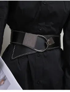 Punk style wide leather waist belt detail, black asymmetric design with metal rivet studs.