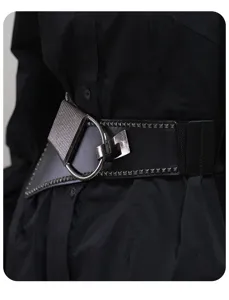 Detail shot of women's wide punk corset belt with metal ring buckle and stud details.