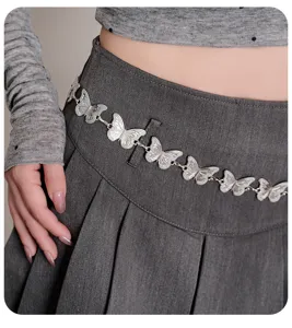 Detail shot of a silver butterfly metal waist chain, showcasing the intricate Y2K design.