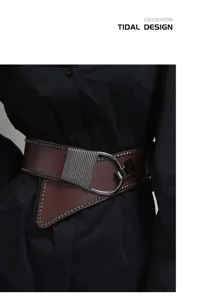Detailed view of women's punk style wide leather belt with rivets and metal buckle.