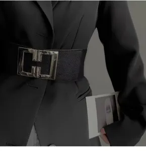 Close up detail of women wide elastic waist belt with stylish silver double buckle fashion.