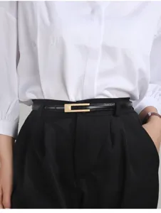 Slim black leather belt for women with elegant gold buckle, perfect detail for chic outfits.