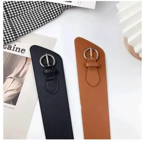 Wide waist belt detail featuring asymmetric angle cut, metal round buckle, and stylish design.