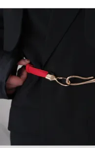 Red thin leather belt with gold metal hook buckle detail for dresses and blazers.