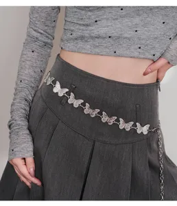 Close-up detail of silver butterfly metal waist chain, perfect for y2k skirts and pants styling.