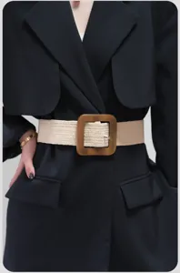 Detail shot of women's wide woven elastic belt with square wooden wooden buckle, stylish.