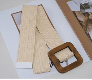 Detailed view of the wide woven elastic belt featuring a wooden square buckle and chic design.