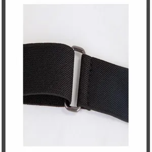Elastic belt metal buckle detail, stretchy black waist strap, adjustable buckle design.