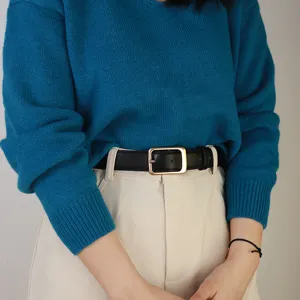 Classic minimalist pin buckle black leather belt worn with casual apparel, front view.