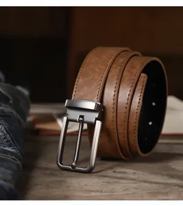Retro brown leather belt detail, classic metal pin buckle, textured casual jeans accessory.