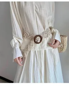 Bohemian woven belt detail shot featuring natural beige wax cord and a dark round wooden buckle.