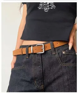 Brown vintage skinny belt with silver metal buckle, stylish retro waist accessory.