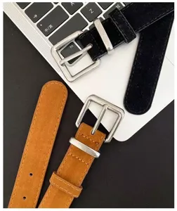 Detail view of women's vintage slim leather belt featuring antique metal buckle and texture.