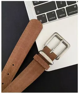 Brown vintage suede belt detail showing retro metal buckle and fine leather texture.