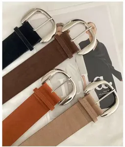 Retro suede belt for women featuring large metal buckle, casual minimalist design for pants.