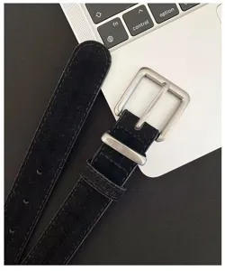 Black suede belt detail featuring vintage metal square buckle and neat stitching design.