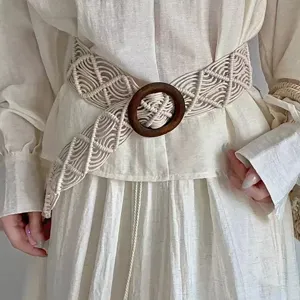 Bohemian handmade woven belt with wooden ring buckle, perfect dress accessory for women.