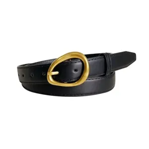 Classic black leather women belt with unique gold metal buckle rolled up on clean background