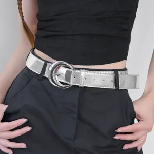 Stylish women's silver metallic leather belt with round metal buckle for dresses and jeans.