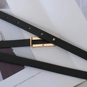 Slim black leather belt for women with elegant gold rectangular buckle minimal design