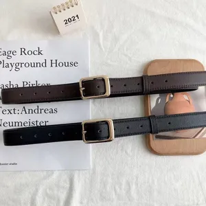 Stylish women's black and brown leather belt with square gold buckle, versatile jeans accessory.