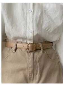 Chic khaki faux leather belt with a delicate metal buckle, perfect for trousers and dress.