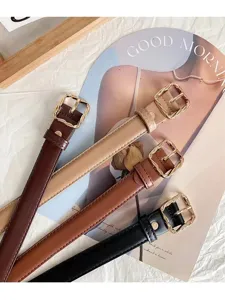 Detailed close-up of stylish women PU leather waist belt featuring unique twisted gold buckle.