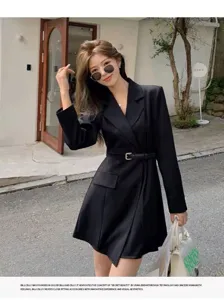 Detailed view of women's stylish black suit jacket blazer with belt, vintage minimalist design.