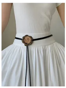 Detail view of the French style rose flower waist belt featuring a chic black leather strap.