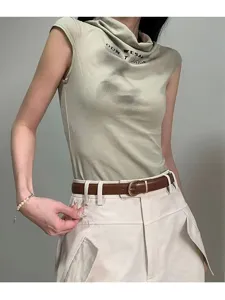 Close-up detail of the stylish brown leather belt with metal buckle, paired with casual outfit.
