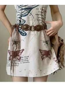 Tribal retro style printed mini dress with vintage studded tassel waist belt accessory.