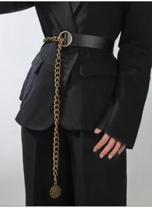 Detailed view of women's black leather belt featuring a long gold chain with vintage coin pendant.