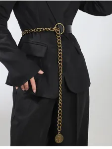 Detailed view of women's decorative chain belt with gold coin pendant for stylish suit styling.