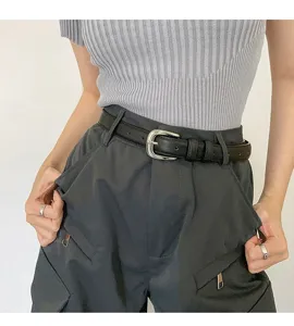 Minimalist black leather belt for women, featuring a sleek silver buckle for versatile daily wear.
