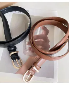Thin leather belt detail showing dual color options and elegant metallic buckle design.