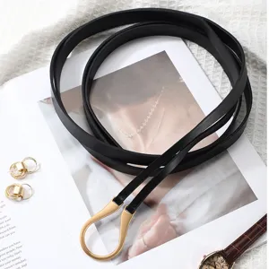 Black thin waist belt with gold U-shaped metal buckle, elegant dress decorative leather belt.