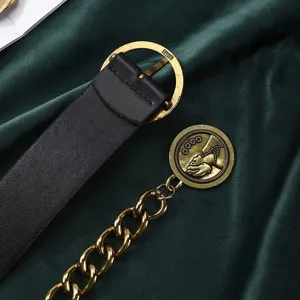 Women vintage black leather belt with gold round buckle and chain tassel, chic dress waist accessory.