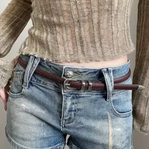 Minimalist thin leather belt for women, retro fashion waist accessory for jeans and summer dresses.